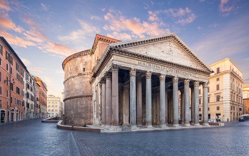 Tourists admiring the massive columns and architecture of the Pantheon