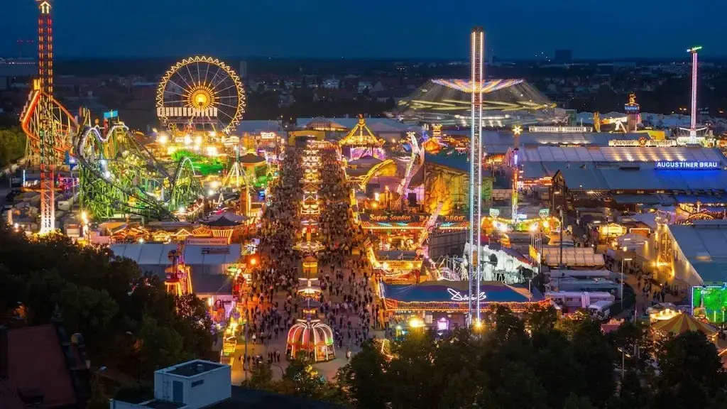 Aerial view of the Theresienwiese fairground illuminated at night during Oktoberfest