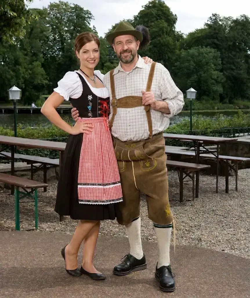 Man and woman dressed in traditional Bavarian lederhosen and dirndl at Oktoberfest