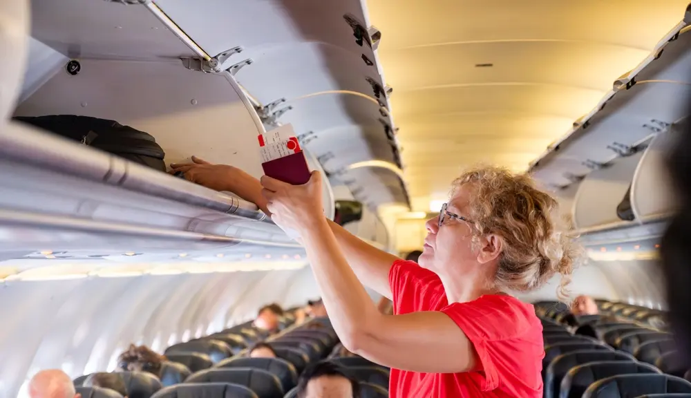 Passenger organizing luggage during boarding